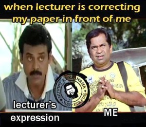 Lecturer Correcting Paper In Front Of Me